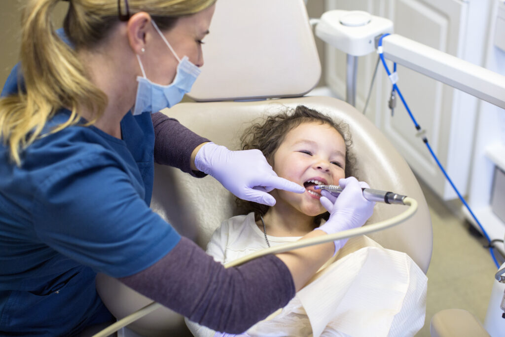 Child receiving dental crown treatment at a pediatric dentist office in Highland